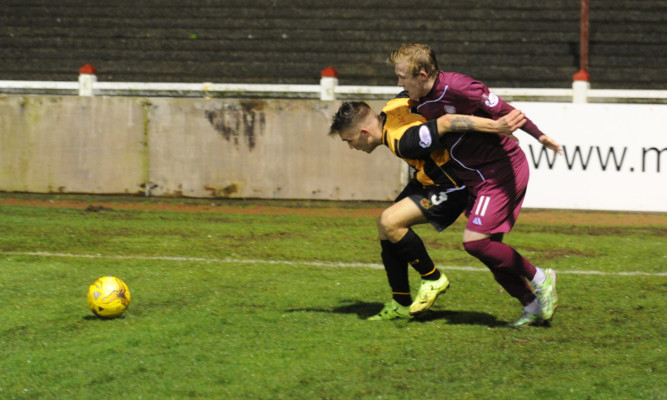 Berwicks Callum Crane, left, holds off Darren Ramsay, though the Arbroath striker was to have the last laugh when his fine long-range strike sealed the win.