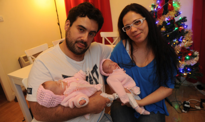 Bruno Silva and Filipa Geraldes with their twin daughters Aileen and Deborah.