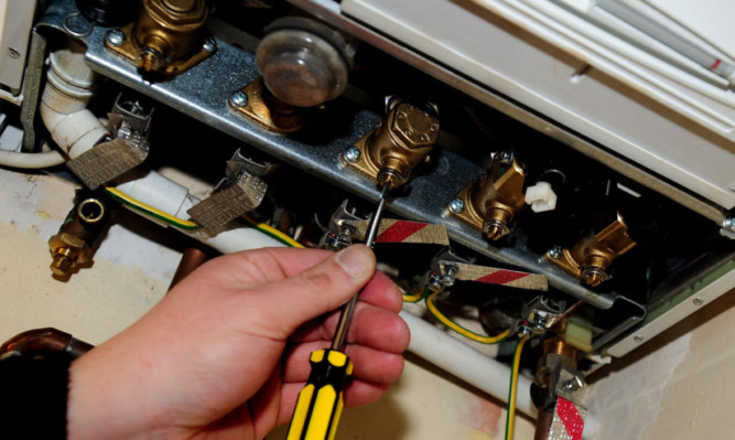 A plumber working on a gas boiler as 28,000 private renters could be at risk from gas safety hazards, according to housing charity Shelter Scotland.