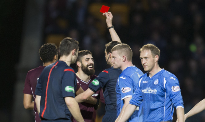 Hearts player Juanma (centre) is shown the red card.