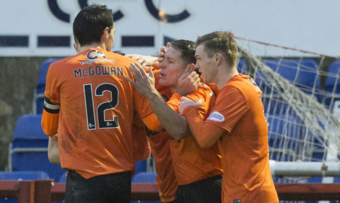 Dundee Utd's John Rankin celebrates his goal with his team-mates after opening the scoring.