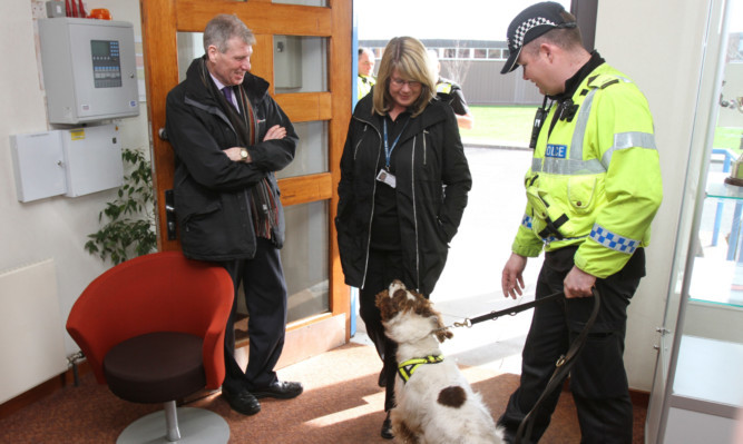 Kenny MacAskill with Constable Ryan Galloway and Buddy who is working, sniffing for drugs, at Baluniefield Police Station, Dundee.