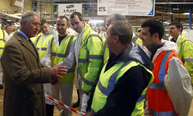The Prince of Wales talks to workers during a visit to the McVitie's factory in Carlisle, which was damaged in the floods earlier in the month.