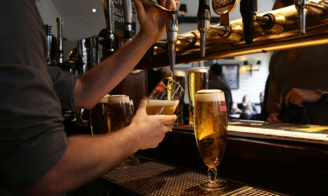 Drinks being poured at the bar of Irish pub O'Neill's in Carnaby Street, central London. PRESS ASSOCIATION Photo. Picture date: Friday April 18, 2014. Photo credit should read: Yui Mok/PA Wire
