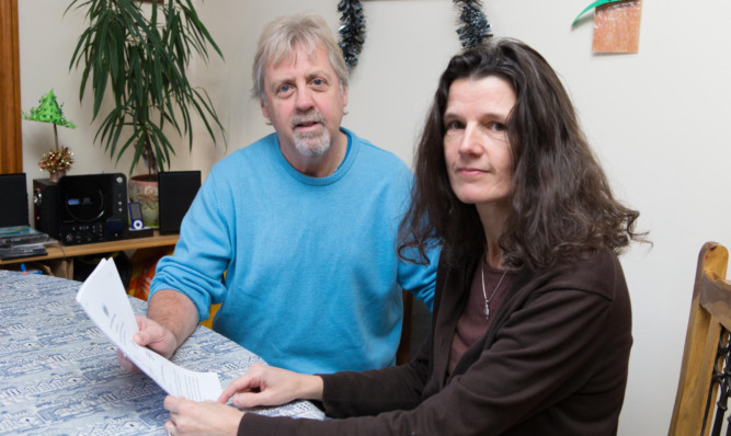 David Mitchell with fiancée Hilary Lumsden and the court documents showing settlement of his redundancy and verdict for unfair dismissal.