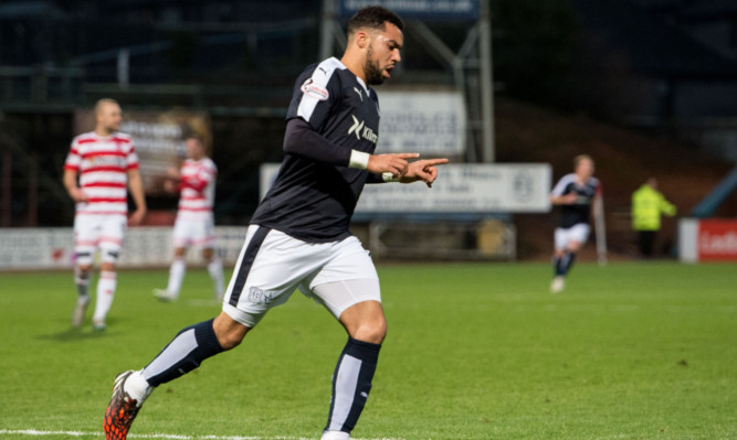 Kane Hemmings races off to celebrate his third goal against Hamilton.