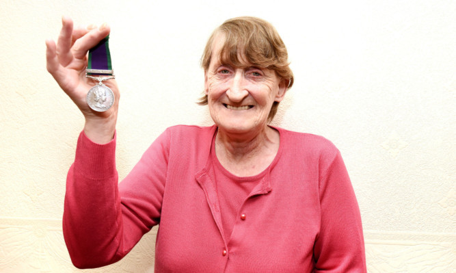Mrs Morrison with her husband's medal.