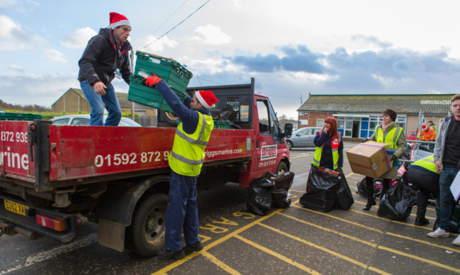 Volunteers and Cottage Family staff assist in the preparation and distribution of the donations.