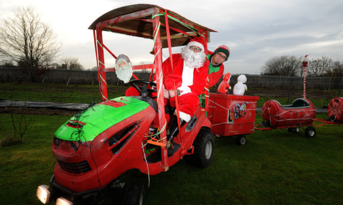 Bobby Tomlinson, left, and John Shields on their homemade Santa train.