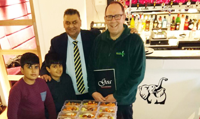 Ibrar Ibrahim with grandsons Adam and Humza and Ken Linton, right, of Dundee Foodbank.