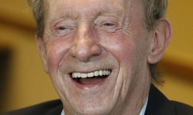 Denis Law lends picks up a CBE for services to football and charity.