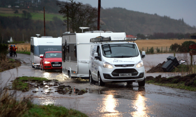 Caravans leaving the Travellers site at North Esk Park as flooding hit the area.