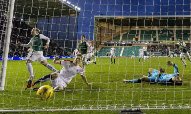 Jason Cummings nets the rebound from his penalty to open the scoring.