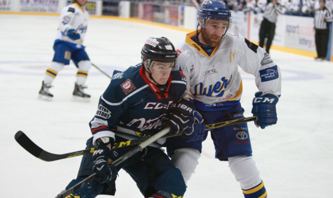 Stars Craig Moore, left, and Flyers Tommy Muir tussle for the puck.