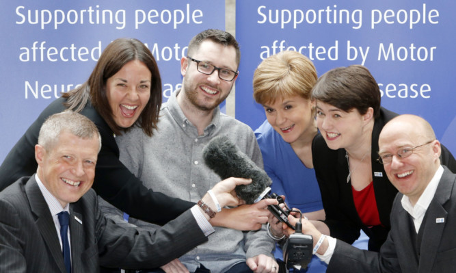 Motor Neurone Disease patient and campaigner Gordon Aikman (centre) meets politicians (left to right) Willie Rennie, Scottish Liberal Democrat leader; Kezia Dugdale, Scottish Labour leader; First Minister Nicola Sturgeon; Ruth Davidson, Scottish Conservative leader and Patrick Harvie, Scottish Green Party leader during a photocall at the Scottish Parliament in Edinburgh to mark Motor Neurone Disease Awareness Week in June.
