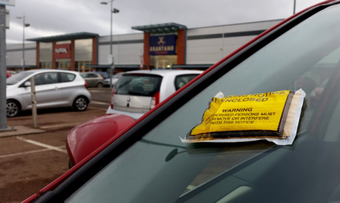 Kris Miller, Courier, 27/01/15. Picture today shows general view of a ticket on a car at UKPC car park at Gallacher Retail Park, Dundee for story about parking fines.
