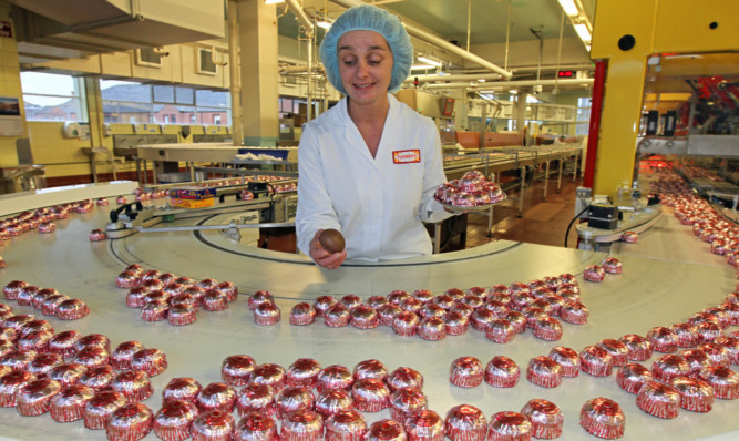 Maria Henderson tasting and testing Tunnocks teacakes. However, the firm has been criticised by some Nationalists for branding its products British rather than Scottish.