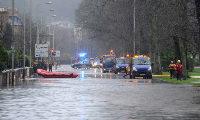 Firefighters and rescue specialists were called in to deal with the flooding on Marshall Place in Perth.