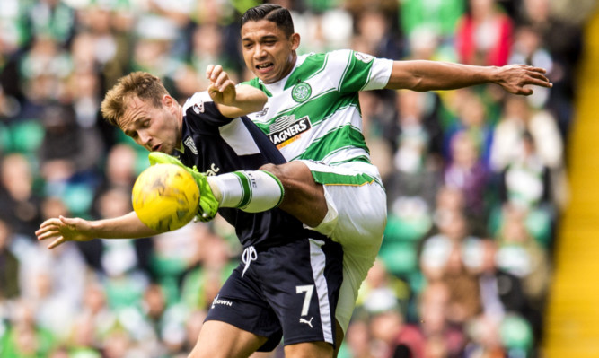 Emilio Izaguirre (right) challenges Greg Stewart in a previous clash between the teams.