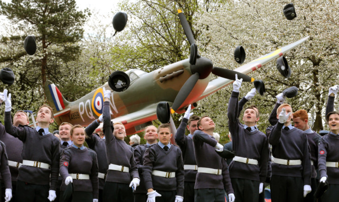 Cadets from the 1333 (Grangemouth Spitfire) Squadron Air Training Corps throw their berets in the air after the replica Spitfire was unveiled.