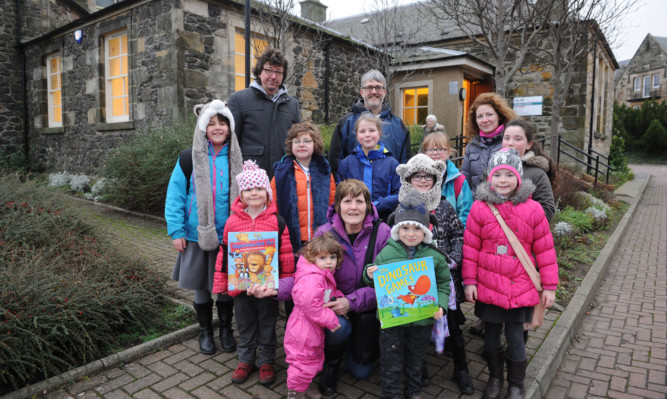 Youngsters and parents outside Kinghorn Library which will remain open for at least a year.