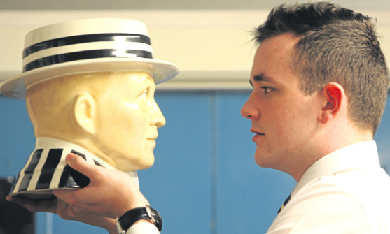 Auctioneer  Robert Guthrie with a Bing Crosby bust.