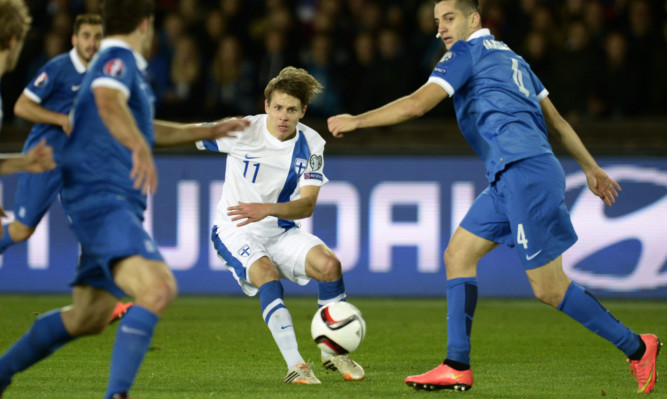 Riku Riski (centre) in action for Finland against Greece.