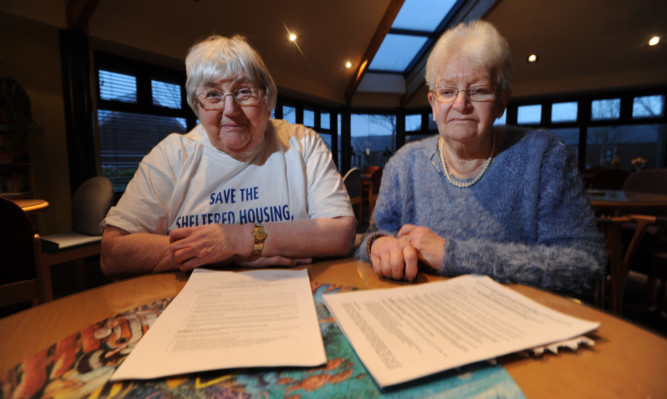 From left: Residents Beatrice Gerrard and Val Laing with a copy of the Angus Council sheltered housing report.