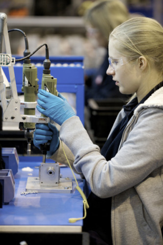 A technician works on a fuel systems part at Tokheims factory in Dundee.