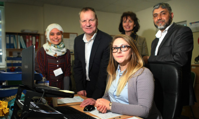 From left: Support officer Eman Hani, Pete Wishart MP, Agnieszka Lukacz, Susan Nicolls and service manager Mohammed Afzal.