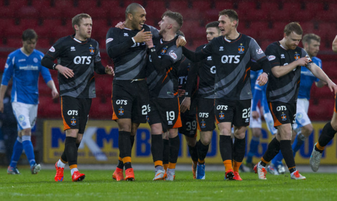 Kilmarnock's Craig Slater (19) is congratulated by teammates after scoring.