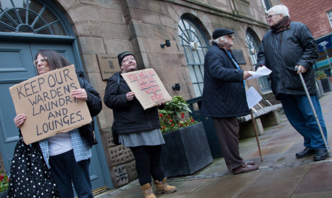 Campaigners stage a protest outside the social work meeting in Forfar