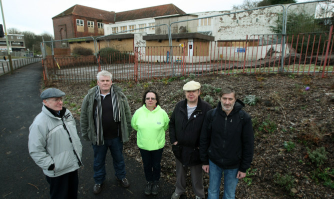 Community group members, from left, David Jordan, Andy Drummond, Alison Walker, David Harrison and Albert Dunbar outside the former school.