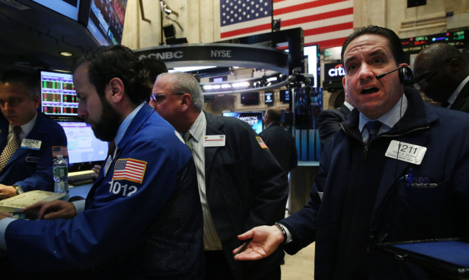Anxious faces on New Yorks stock exchange as predictions of tough times ahead sink in.