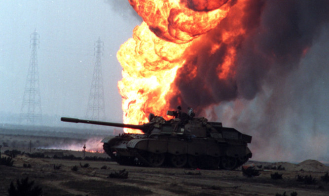 Burning oil fields in Kuwait behind an abandoned Russian-built Iraqi tank after Operation Desert Storm during the Gulf War.