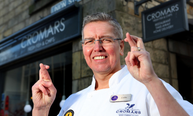Fish and chip shop owner Colin Cromar has his fingers crossed.