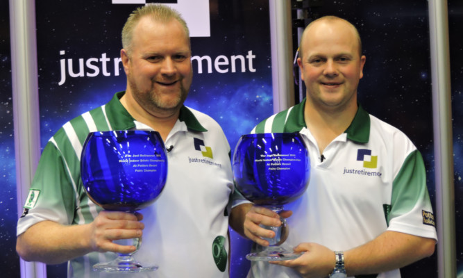 Darren Burnett and Stewart Anderson with their world indoor bowls titles.