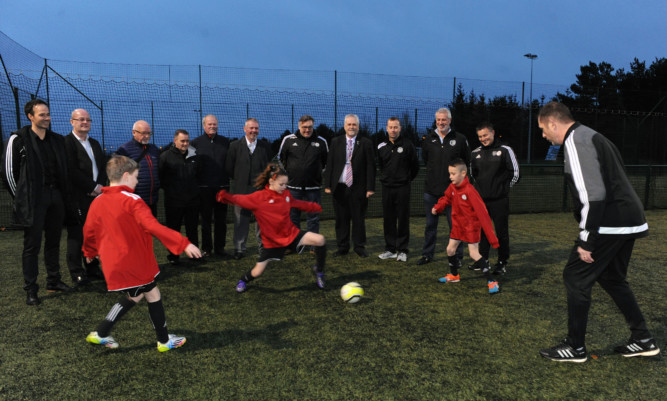 Performance Director of the SFA Brian McClair, Executive Committee Member Cllr Mark Hood and Chair of the Glenrothes Area Committee Cllr Bill Brown watch members of the Fife Football Performance Academy show off their skills.