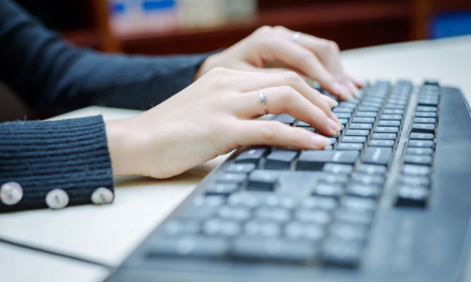 Closeup portrait of woman's hand typing on computer keyboard