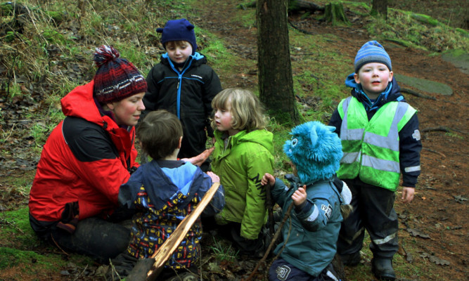 Practitioner Sarah Hutcheon with some of the children from the Secret Garden Outdoor Nursery in Fife.