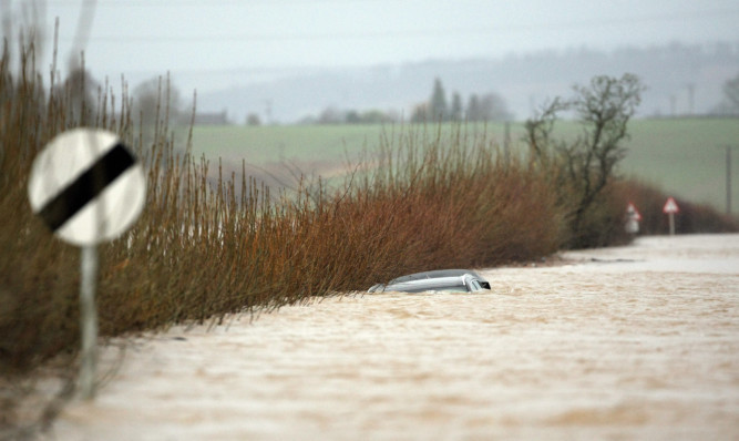 Several drivers were seen trying to beat the floods on the A923 near Coupar Angus.