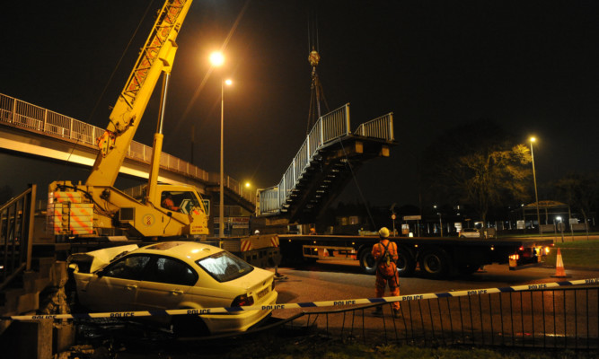 The BMW being removed from the crash site on Thursday.