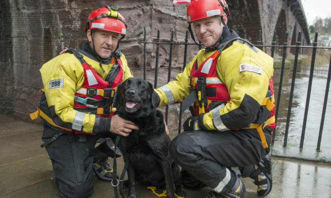 Water rescue team members Tam Brown and Jamie Crawley with Tess after Sunday's dramatic rescue from the River Tay.