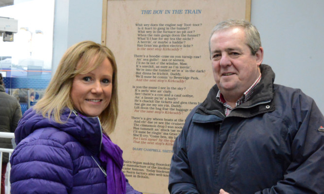Suzie Dempsey and Bill Harvey with the poem at Kirkcaldy Station.