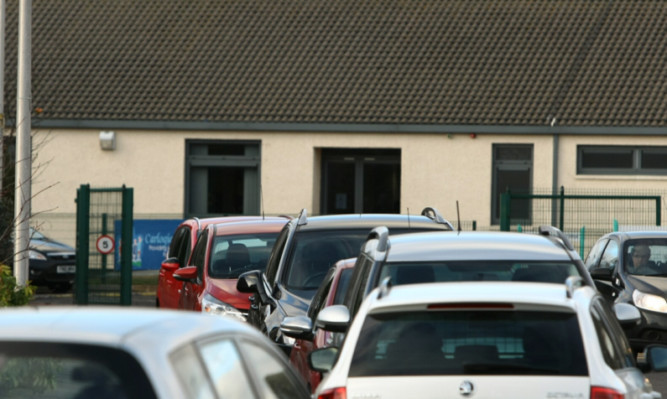 Cars parked outside Carlogie Primary School on Thursday.