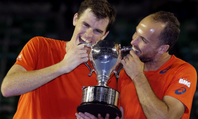 Jamie Murray and Bruno Soares hold their trophy.