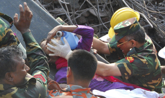 Rescuers carry a survivor pulled out from the rubble 17 days after the building collapsed.
