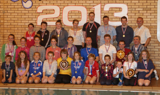 Participants in the 2013 event with their medals and trophies.