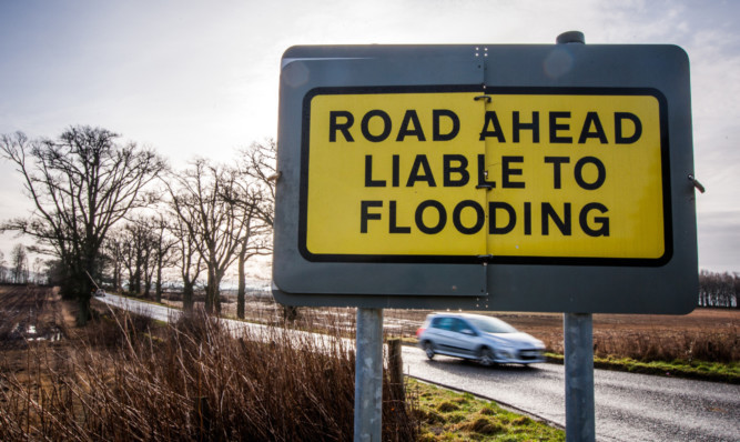 The council is being asked to consider more permanent warning signs in known flooding hotspots.