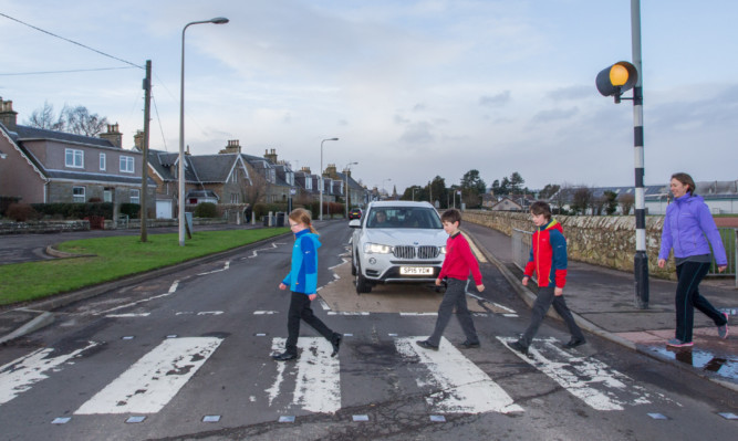 Holly Clark and kids Edie (8), Alex (10) and Sam (11) using the zebra crossing on Ceres Road. Nearby South Road is to get a full traffic light-controlled puffin crossing.